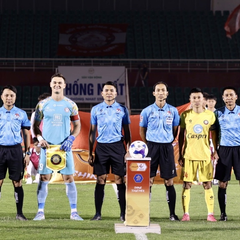 Match officials line up before kick-off at Thống Nhất Stadium with the TP.HCM captain, whose shirt carries the Mansion Sports logo